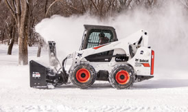 Loader removing snow at night